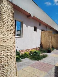 a building with a wicker fence in front of it at Wib Guesthouse in Addis Ababa