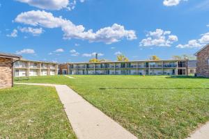 a school building with a grass field in front at Eastlake Suites Hotel & Conference Center By OYO Urbana in Champaign