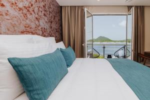 勒马兰Sable Bleu Boutique Hotel的一间带大床和大窗户的卧室