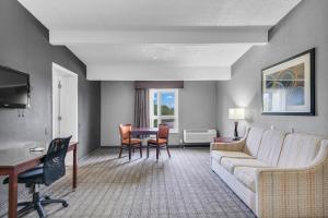 a living room with a couch and a table at Eastlake Suites Hotel & Conference Center By OYO Urbana in Champaign
