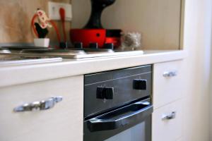 a kitchen with a black oven and a counter at Kuća za odmor Mumi in Gostinjac