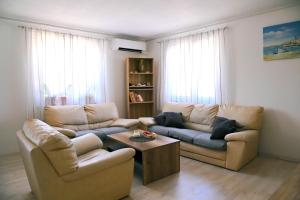 a living room with two couches and a coffee table at Kuća za odmor Mumi in Gostinjac +45 photos