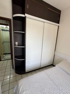 a bedroom with a bed and a large closet at Navegantes apartamento in Recife