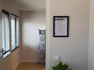 a room with a picture on the wall and a window at Prime Location 1BR Apartment Walk Everywhere in Eindhoven