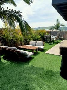 a patio with a table and chairs on grass at נופי ארבל in Livnim