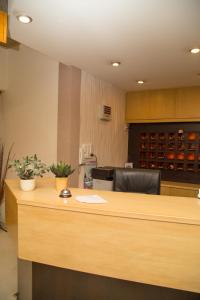 an office with a desk with a chair and a counter at Hotel Niovi in Thiva