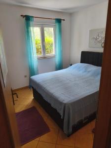 Apartmani Ladaにあるベッド