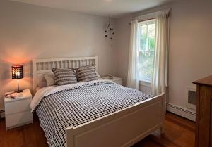 a bedroom with a white bed and a window at Phoenicia Bungalow in Phoenicia