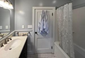a bathroom with a shower door and a sink at Phoenicia Bungalow in Phoenicia +15 photos
