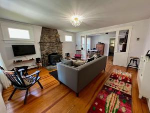 a living room with a couch and a fireplace at Phoenicia Bungalow in Phoenicia