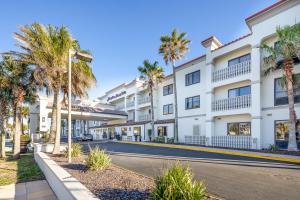 a street in front of a white building with palm trees at Hampton Inn & Suites St. Augustine-Vilano Beach in Saint Augustine