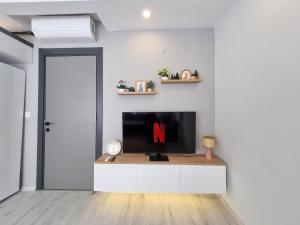 a living room with a tv with the letter n on it at Central Location 2 Bedroom Apt in Antalya