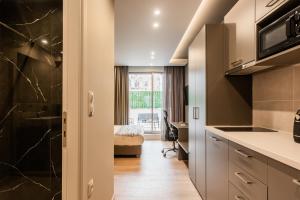 a kitchen with a sink and a desk at WYZ Museum by UPSTREET in Athens