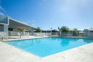 a large swimming pool in front of a building at Casa Isabel at Puerto Bahia steps from the Beach in Rincon