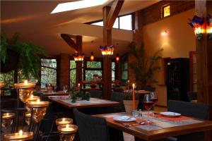 a restaurant with wooden tables and chairs and lights at Oasis Resort & Spa in Rewal