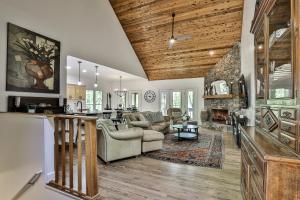 a living room with a kitchen and a living room with a fireplace at Adventures at Big Canoe - Spacious Cabin Rental in Big Canoe - Serene Nature Views, Cozy Fireplace, Spacious Decks, Walking Dist in Afton
