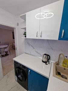 a kitchen with a washer and dryer in a kitchen at Cazare Buzau Lux in Buzău