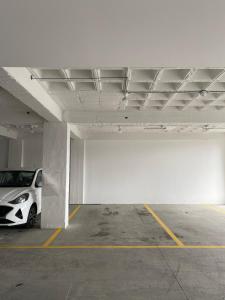 a white car parked in a parking lot at Amaru in Loja