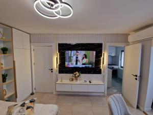 a living room with a flat screen tv and a living room at Cazare Buzau Lux in Buzău