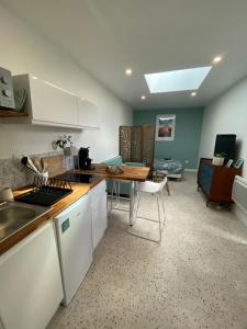 a kitchen with a sink and a table in a room at studio cosy idéalement situé in Angers