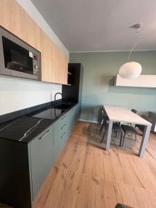 a kitchen with a table and a microwave at Casa Isabella2 in Ferrara +10 photos
