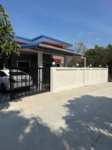 a house with a gate in front of it at PoolvillaLana 3 rooms in Bang Sare