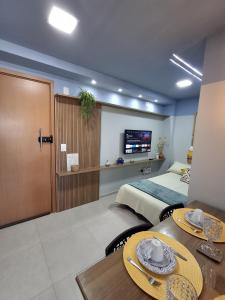 a hotel room with a bed and a table with plates on it at Flat Coqueiros 101 Praia in Tamandaré +36 photos