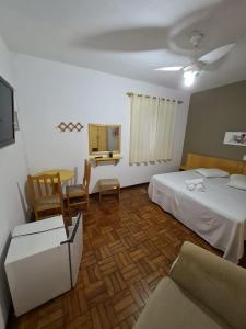 Ένα ή περισσότερα κρεβάτια σε δωμάτιο στο Pousada VITORIA GARDEN