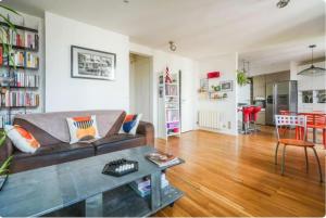a living room with a couch and a table at Sweet home in Paris