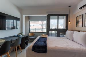 a bedroom with a large bed and a desk with a desk at 360 Soma Perdizes in Sao Paulo +46 photos