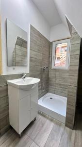 a bathroom with a sink and a bath tub at Cricova House in Colibiţa