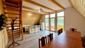 a room with a dining table and a kitchen at Cricova House in Colibiţa