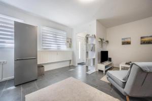a living room with a chair and a refrigerator at Ferienwohnung Heide 2 in Walsrode