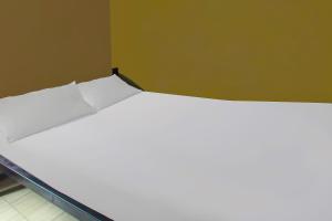 a large white bed in a room at OYO 92308 Kos Duduk in Lajor