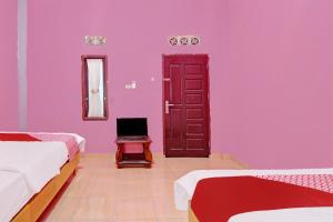 Ένα ή περισσότερα κρεβάτια σε δωμάτιο στο Hotel O Salsa Homestay Syariah Near Pondok Pesantren MUALLIMIN Muhammadiyah Bangkinang Kota