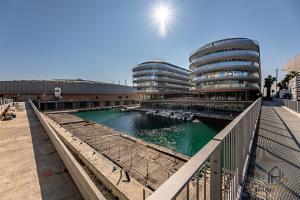 a view of a river with buildings in the background at Luxury by the Sea - Free Park - Gym - UltraWiFi in Genova