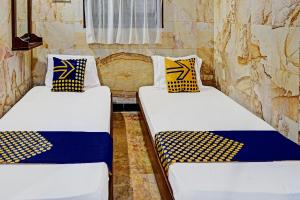 Ένα ή περισσότερα κρεβάτια σε δωμάτιο στο Hotel O Griyo Werdiningsih +22 φωτογραφίες
