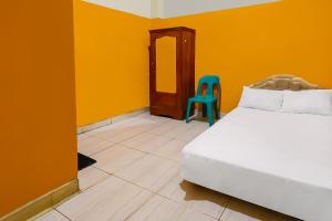 Ένα ή περισσότερα κρεβάτια σε δωμάτιο στο Hotel O Pondokan Tali Super