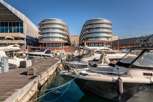 a group of boats docked in a marina with buildings at Luxury by the Sea - Free Park - Gym - UltraWiFi in Genova