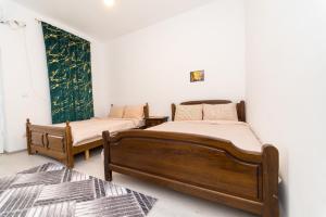 two beds in a room with white walls at Hotel Emir in Strehaia +42 photos