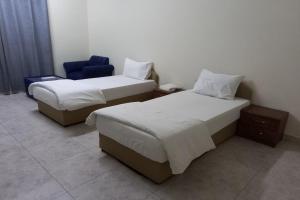 Postel nebo postele na pokoji v ubytování Super OYO 147 Babylon Furnished Apartment