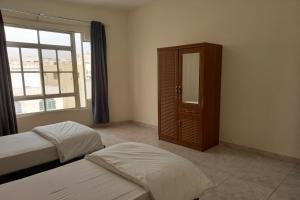Postel nebo postele na pokoji v ubytování Super OYO 147 Babylon Furnished Apartment + 11 fotografií