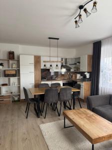 a kitchen and dining room with a table and chairs at Wohnungen Beshi Niederthalheim in Vöcklabruck