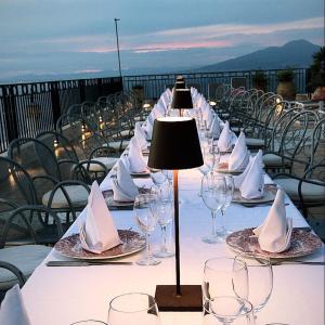 a long table with wine glasses and napkins on it at Hotel Villa Pina Antico Francischiello in Massa Lubrense