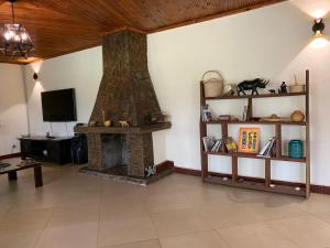 a living room with a fireplace and a tv at Summerfields & Gardens Lodge in Kitwe