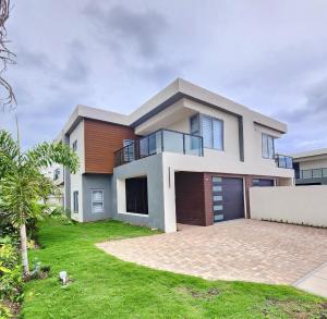 a house with a large driveway in front of it at The Onyx Villa by MTJ Properties Ocho Rios in Laughlands