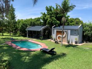 a house with a swimming pool in the yard at Summerfields & Gardens Lodge in Kitwe