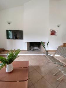 a living room with a fireplace and a tv at keronia house in Stalida