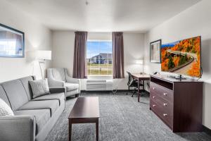 EatonCobblestone Hotel & Suites - Eaton的带沙发和书桌的客厅