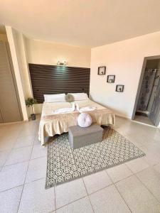 a bedroom with a large bed and a rug at Gloria Suites at Pension Candelaria in Valle Gran Rey